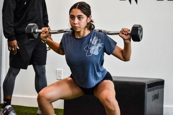 Squat with EZ curl bar