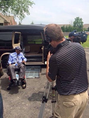 Scott Rowland shooting at presentation of vehicle to disabled veteran at Motorcar Makeovers