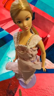 This gorgeous Barbie in an elegant pink dress accented with sequen and lace.