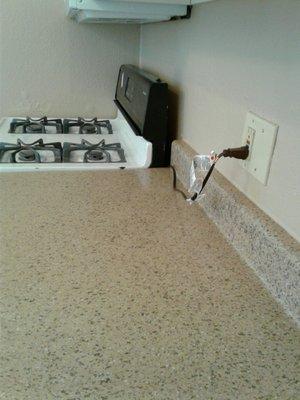 Extension cord used to hook up a stove! It's a fire hazard and illegal!