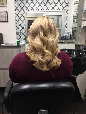 Highlights, and styled with luscious curls.