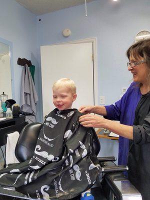 Alivia finishing cutting my son's hair. We love Niwot Barber Shop!