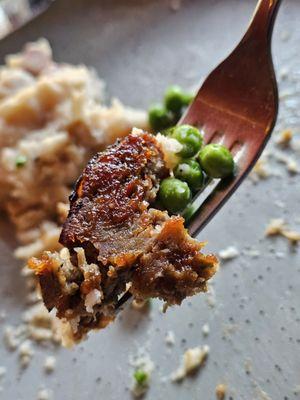 The Smoked Seven Hills Meatloaf with brisket, pork, shoulder, house bacon, peas, and carrots.