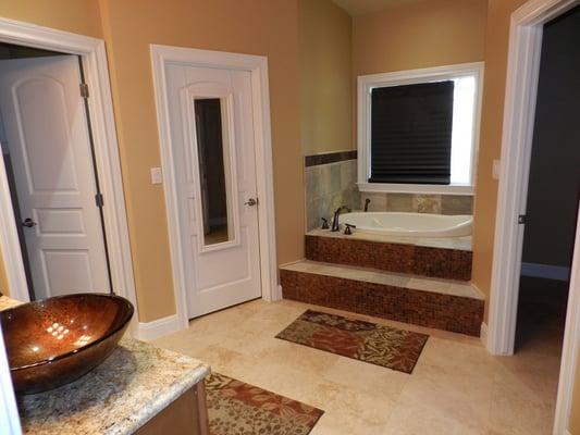 Copper plated tiles with slate around it. Travertine floor wtih matching sinks.