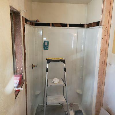 NEW FIBERGLASS SHOWER KIT INSTALLED AND READY FOR DRYWALL PATCH.