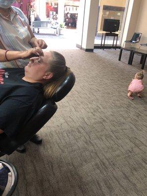 Getting her eyebrow did