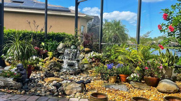 The fountain end of our lanai, trying to arrange before we put them in real pots.