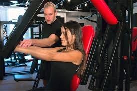 Scott encouraging proper form on the MedX chest press machine.