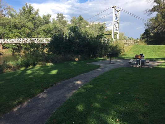 Picnic bench and barbecue near the south end of the foot bridge