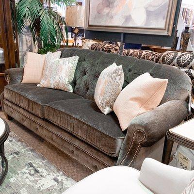 Beautiful tufted sofa with blush pillows