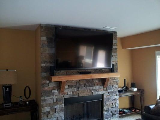 70" Sharp mounted on a stone fireplace with full 5.1 surround sound.