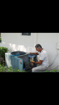 David working on an air conditioner.