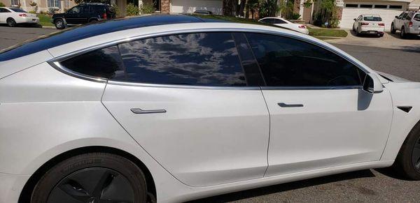 2018 Tesla Model 3 - Suntek Carbon 5 on back windows. Suntek Carbon 20 on front doors.