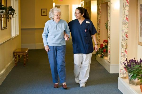 Caring staff assisting a resident