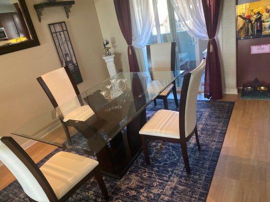 Glass dining room table and white leather(y) and dark wood dining room chairs