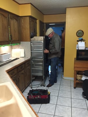 Larry Garner performing his expertise on a built-in double oven unit.