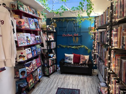 Full view of the reading couch and the children's book wall at Da Book Joint