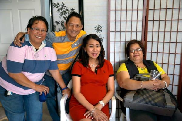 Armando with Elisa Lao, office manager and two happy and satisfied clients in the AATS office after their brief tax session.