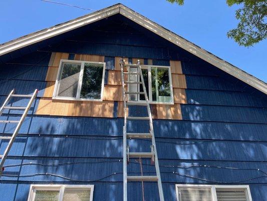 High quality raked cedar siding used around a window replacement.