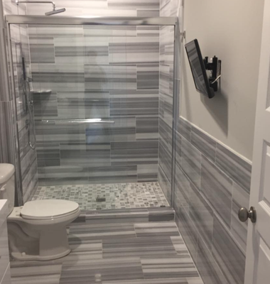 We renovated three commercial floors from retail spaces to three floors of condominiums all the grey tiling bathrooms and showers