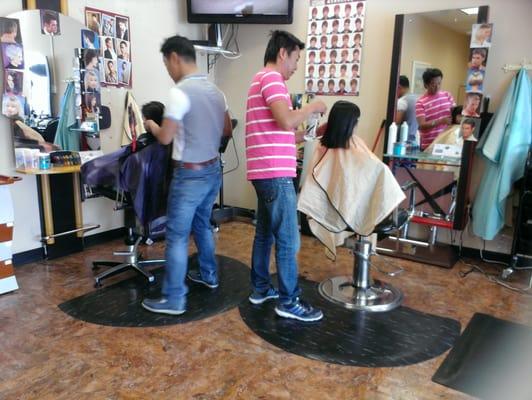 Hair stylists cutting the girls' hair.