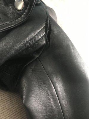 Leather jacket with tear.