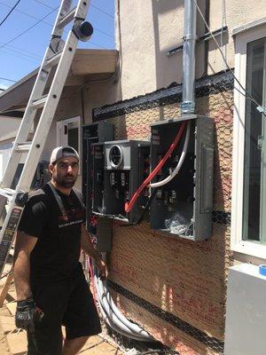 Henry working on a large panel for an apartment building.