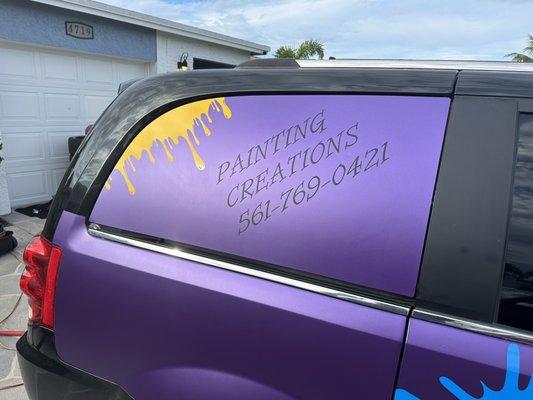 Custom satin purple wrap on window. Custom cut vinyl lettering and images applied.