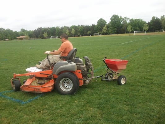 A professional team member liming ball fields in Centreville, VA.