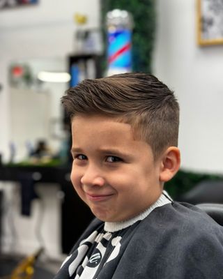 A classic kids combover with scissors on top with a slight touch of pomade