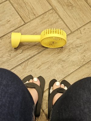 Closer view of basic pedicure with small fan in front entrance sitting area