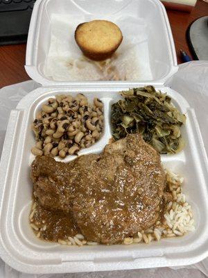 Smothered pork chop with mixed greens and black eyed peas