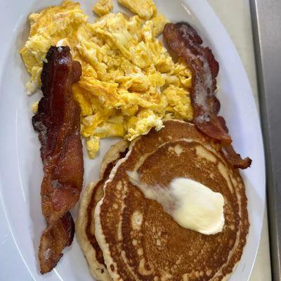 Pancake breakfast with your choice of eggs and choice of bacon or sausage