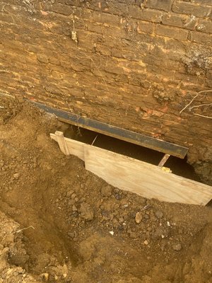 Underpinning a foundation that had home heating oil contamination 16' below the footing