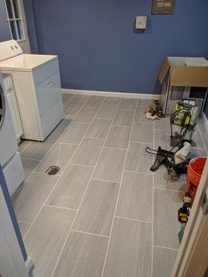 one of our many tile installs laundry room