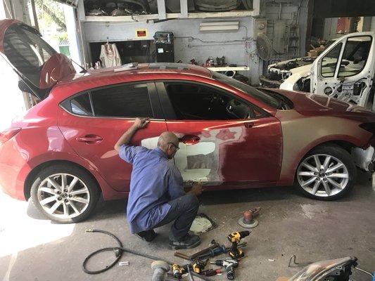 My main man repairing doors that Geico should've replaced ,we fought and fought but wouldn't replace ,but we get the job done