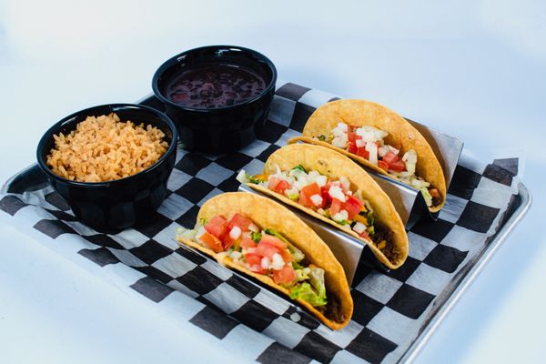 Knucklehead Tacos - Meat Choice with lettuce, tomatoes, onions, & shredded cheese. Served with side choice.