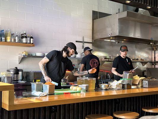 Chefs prepping in the open kitchen.