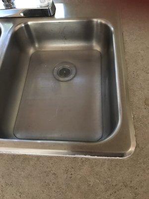 Grey water left in the sink upon delivery