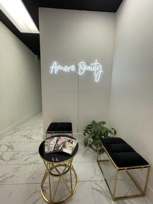 Amore Beauty neon light, seating area