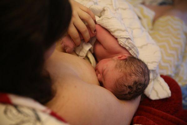 Little Asher skin to skin with his mother right after birth.  Asher was born into the water in his Springfield home.