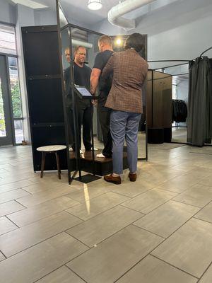 Getting measured for a 3-piece suit