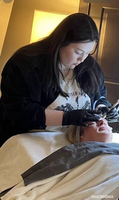 Rebekah doing what she loves, treating your skin.