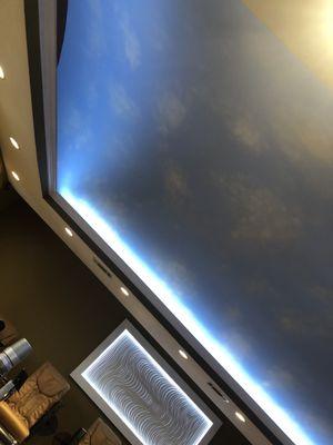 Ceiling is painted like a sky with clouds