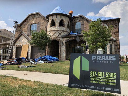 Praus Construction crew working on our roof. Sign in yard keeps the storm chasers away!