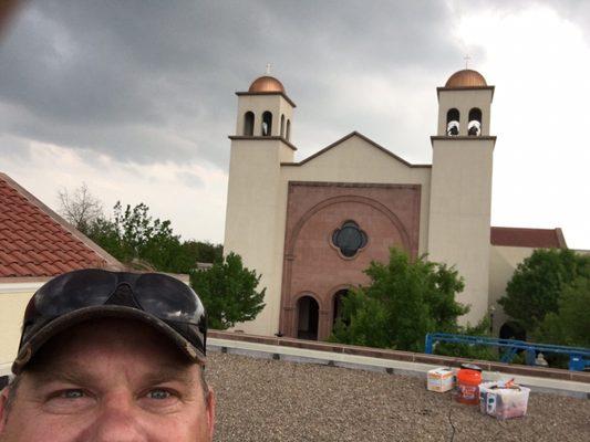 Saint Ann's Catholic Church working on caulking the expansion joints on the roof.