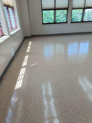 The completion of a completely stripe and waxed hallway vinyl floor.