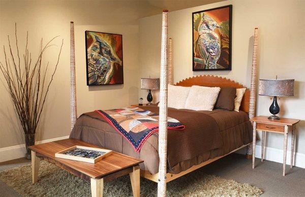 Handmade bedroom set and artwork at New Morning Gallery.