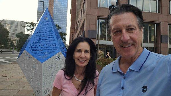 ROSARIO S. CASSATA AND CAROLYN BY THE CLEVELAND CRYSTAL AT THE WEST MALL IN DOWNTOWN CLEVELAND OHIO.