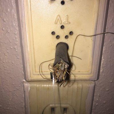 Before repair. The cord was run through the attic and pulled out of the wall to plug into the wall using the outlet below.